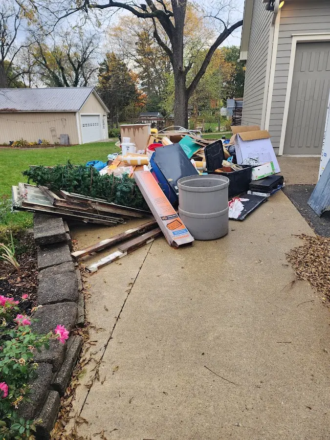 Dumpster being loaded with debris for 12 Yard Dumpster Rental in Weymouth Town